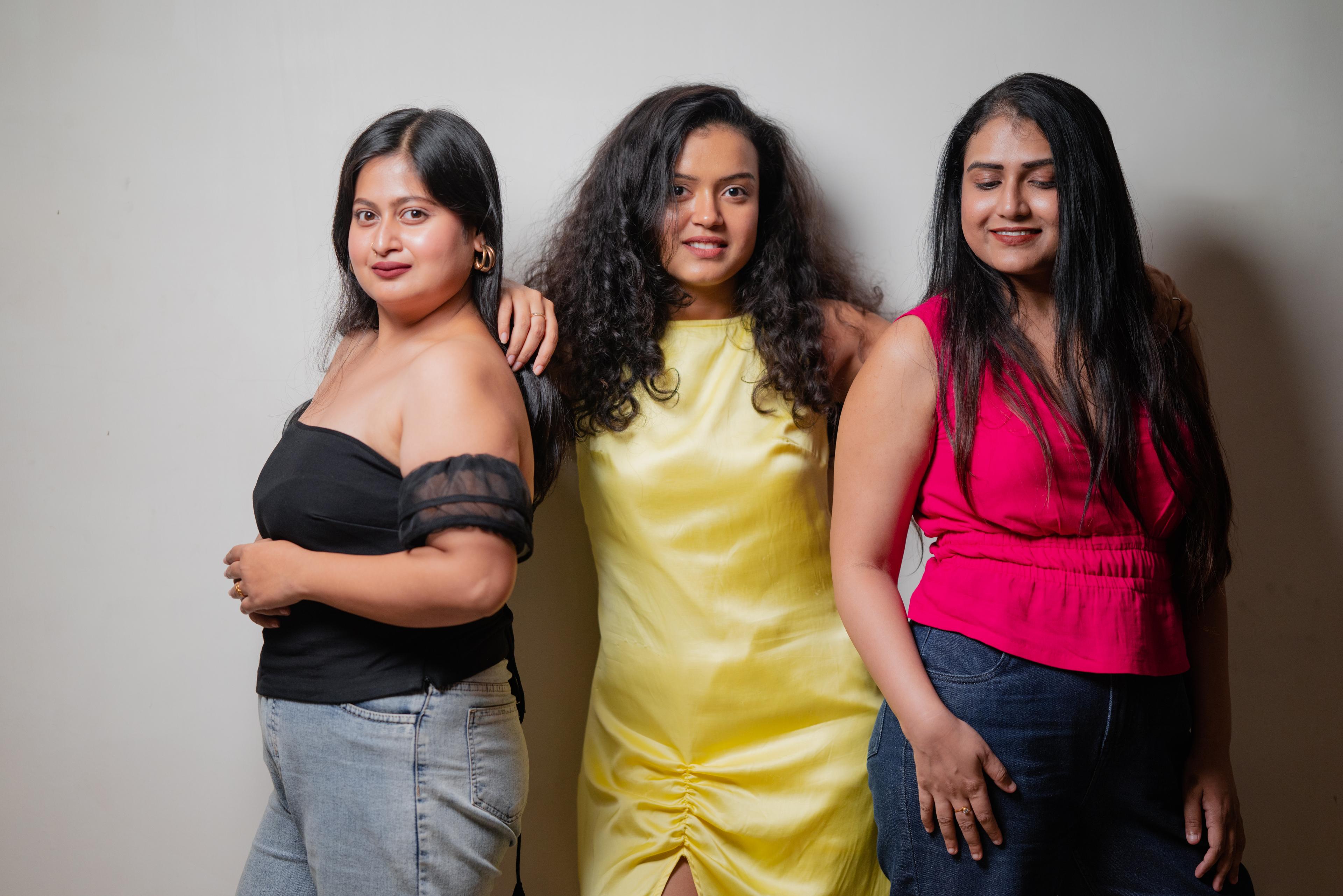The women of SAMAA in the Vesper top, the yellow dress and the pink V-neck top